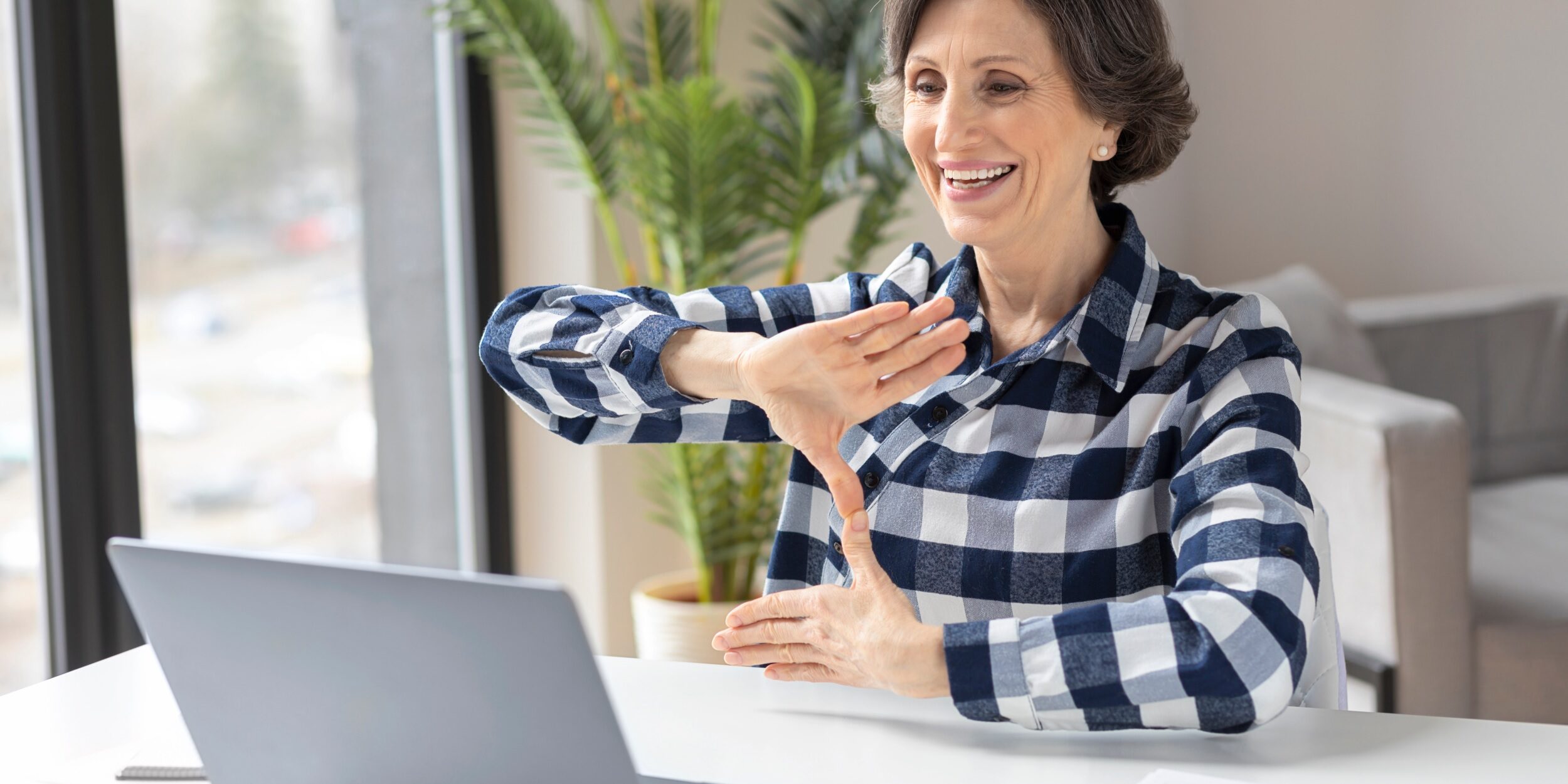 Deaf,Elderly,Woman,Uses,Sign,Language,While,Video,Call